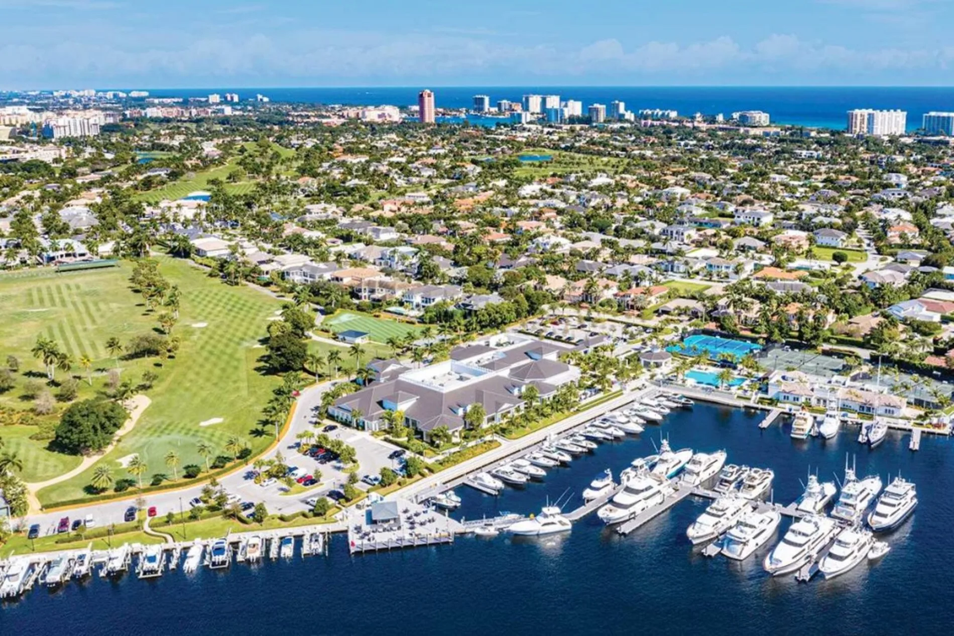 Aerial view of luxury homes surrounding a championship golf course in Boca Raton, Florida, near exclusive country clubs like Royal Palm and Boca West.